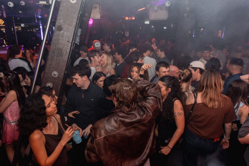 Packed dancefloor in haze and coloured light