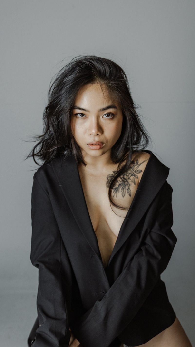 Studio portrait in an oversized black blazer
