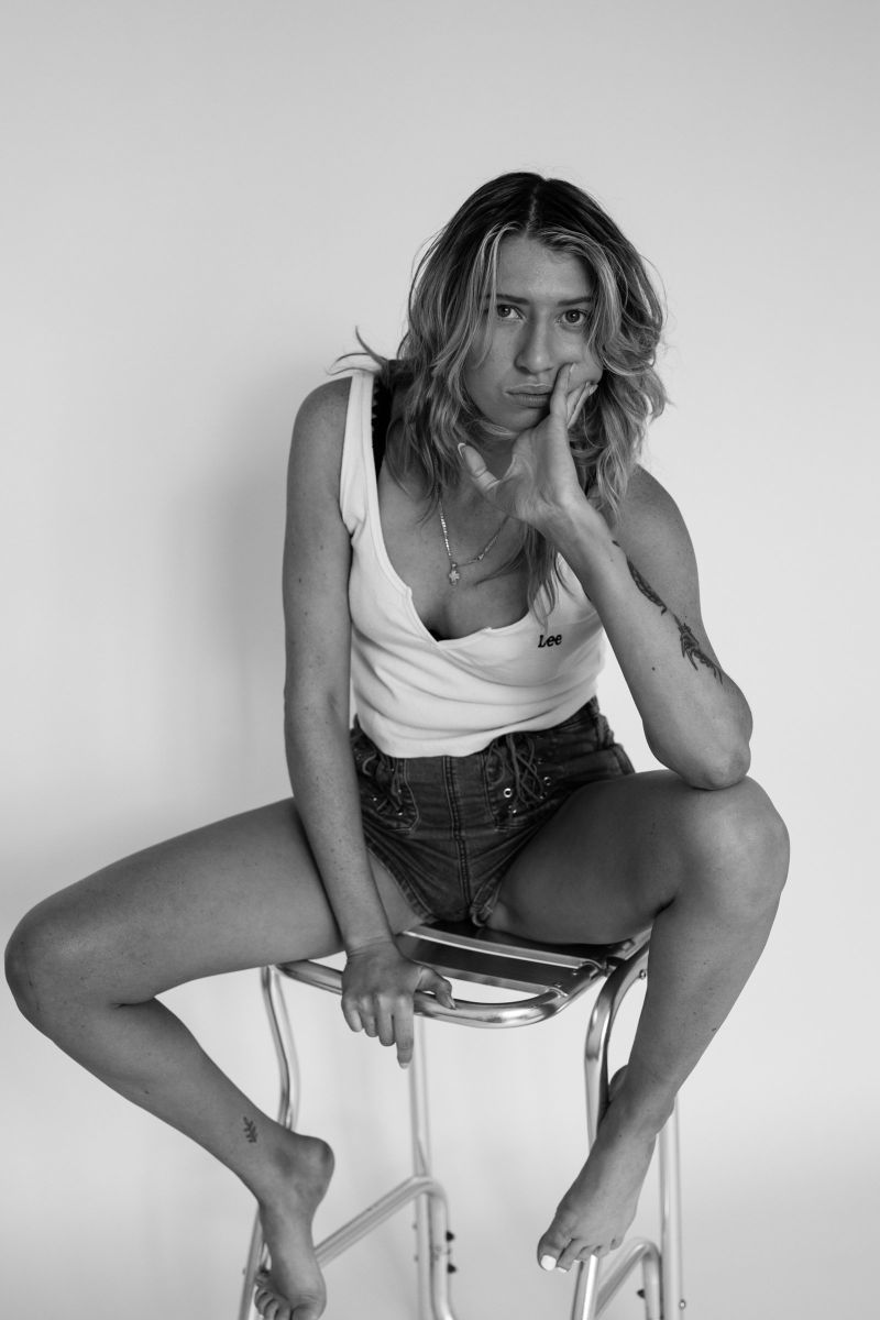 Black and white portrait on a metal stool