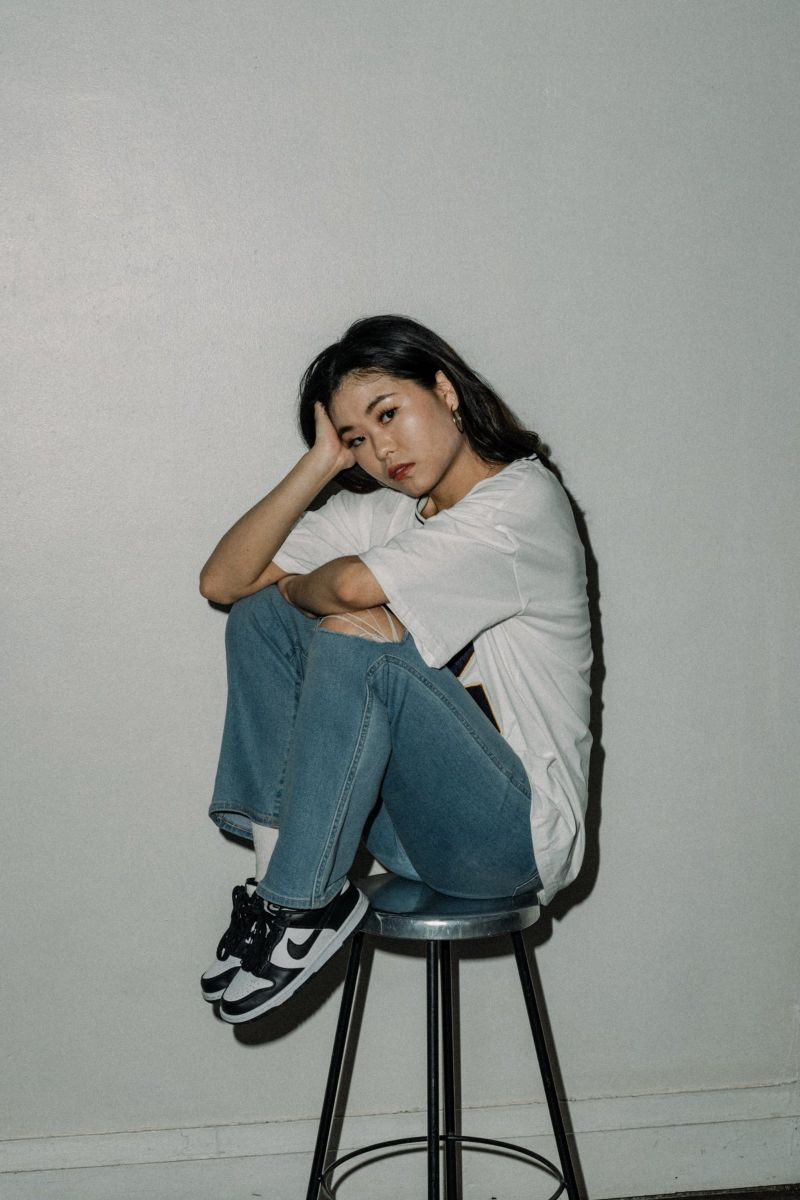 Seated portrait in a jersey and jeans
