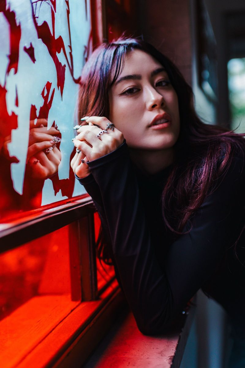 Portrait against a red stained-glass window