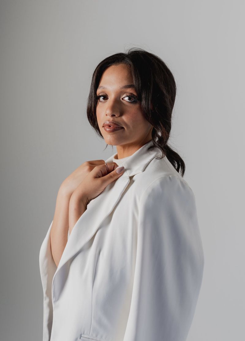 Portrait looking over the shoulder in a white blazer