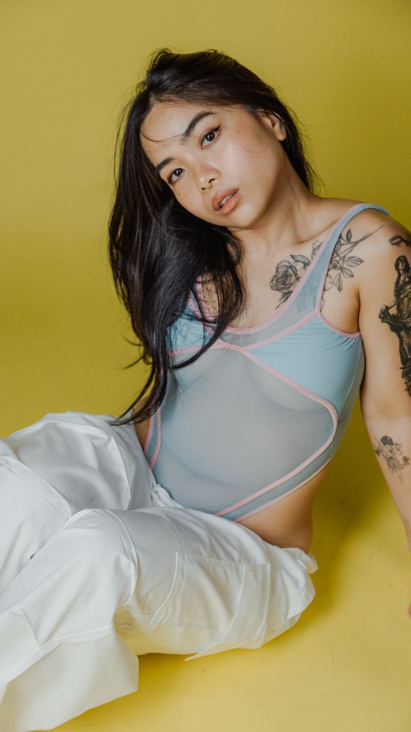Seated portrait on a yellow backdrop