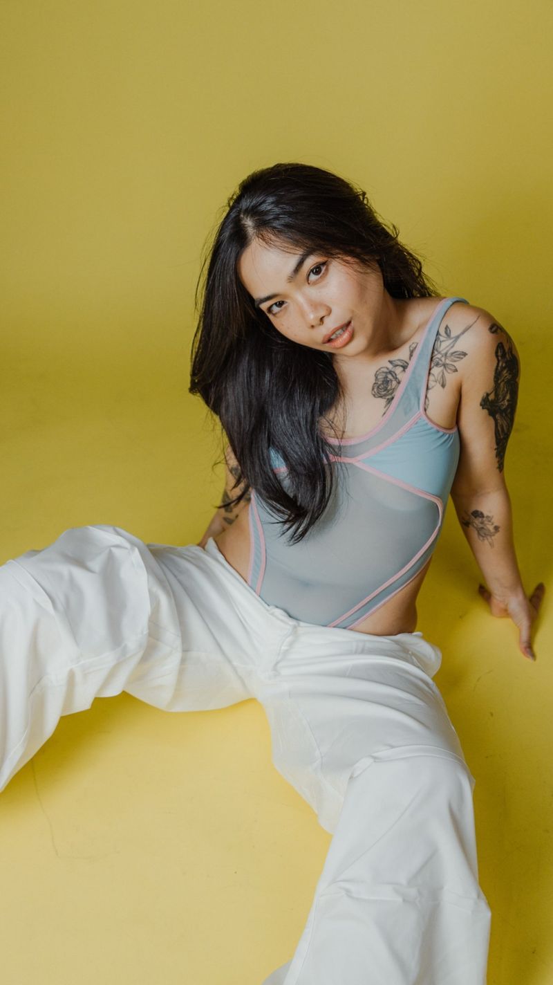 Portrait sitting on a yellow studio floor