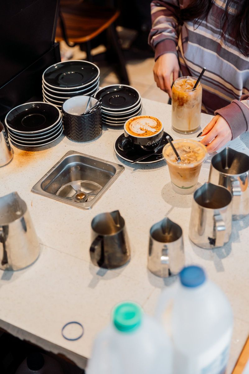 Coffees and iced lattes waiting on the pass