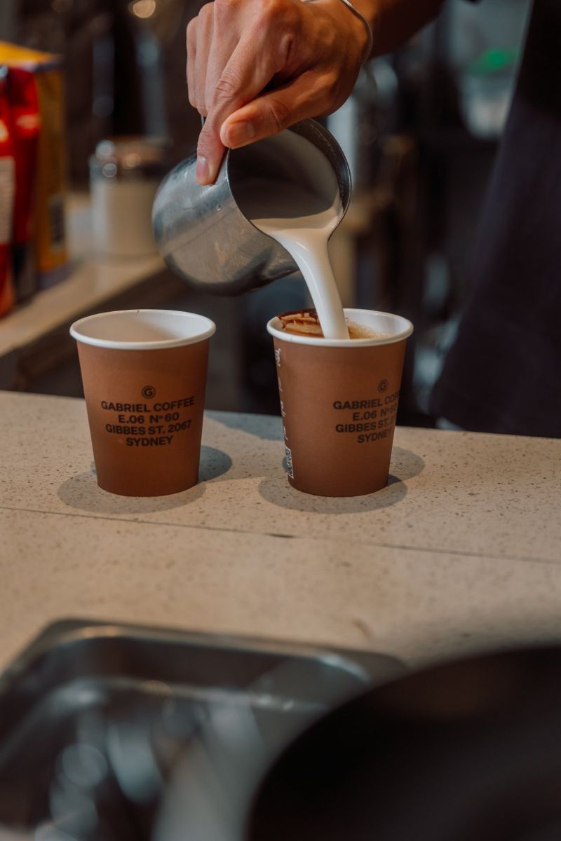 Milk pour into Gabriel Coffee takeaway cups